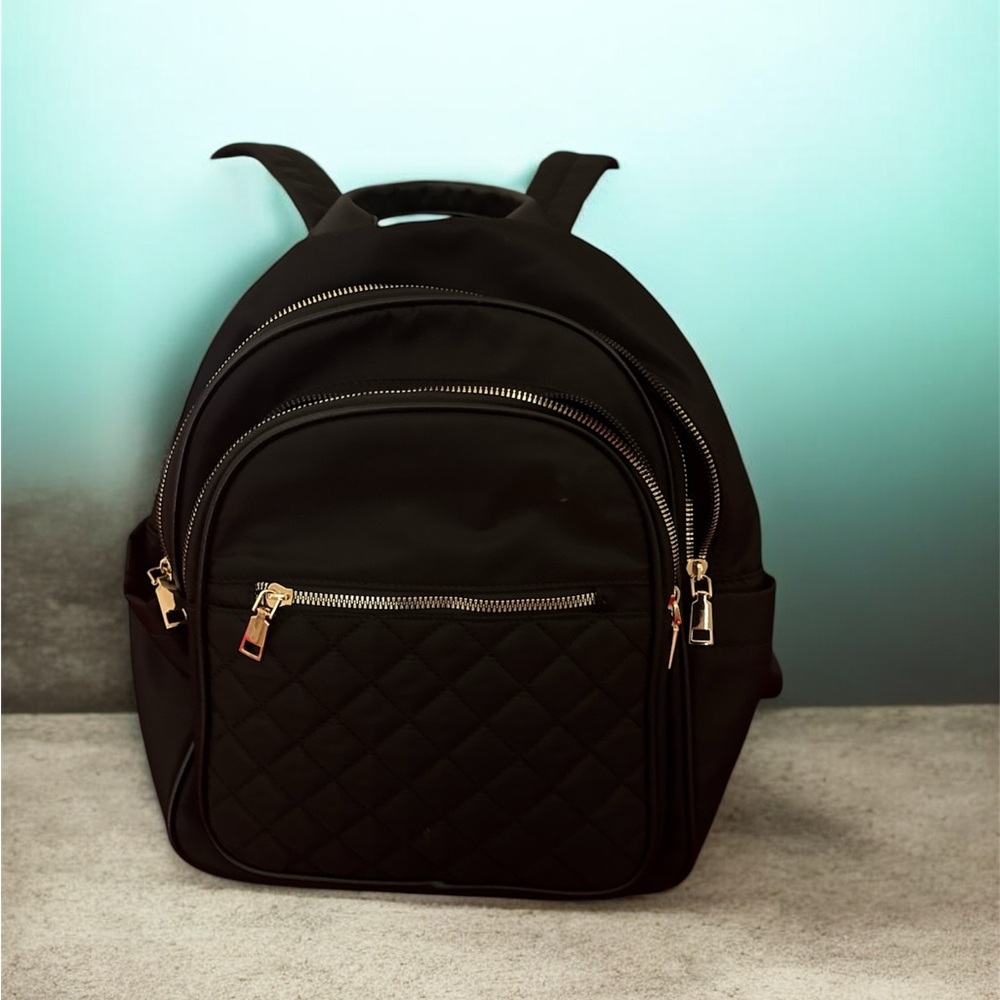 Black padded backpack with gold zippers – elegant style